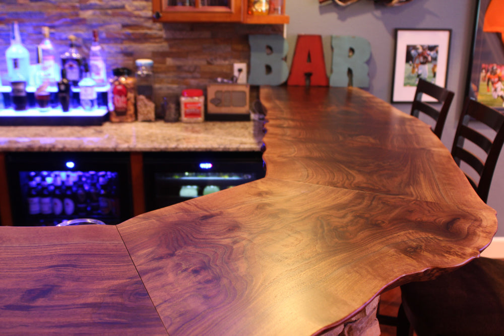 Live edge Claro Walnut bar top with custom shape. The best man cave ever!