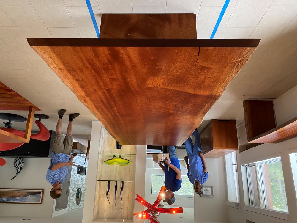 Bubinga live edge dining table made by CS Woods with matching console table in modern art inspired home