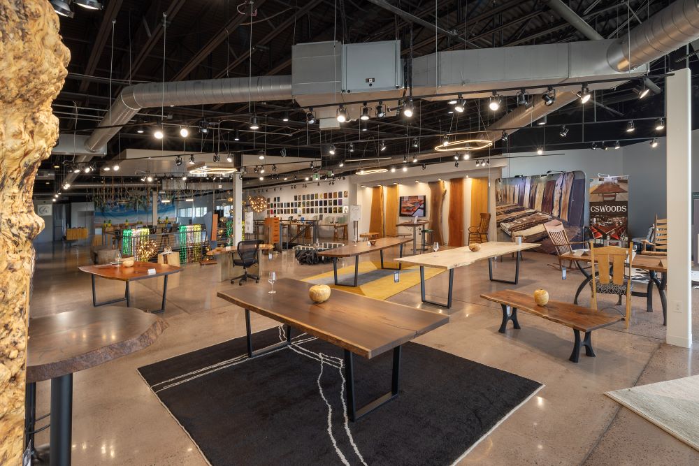 CS Woods showroom at the IDC in Denver featuring a variety of slab solid wood spec tables now available for install.