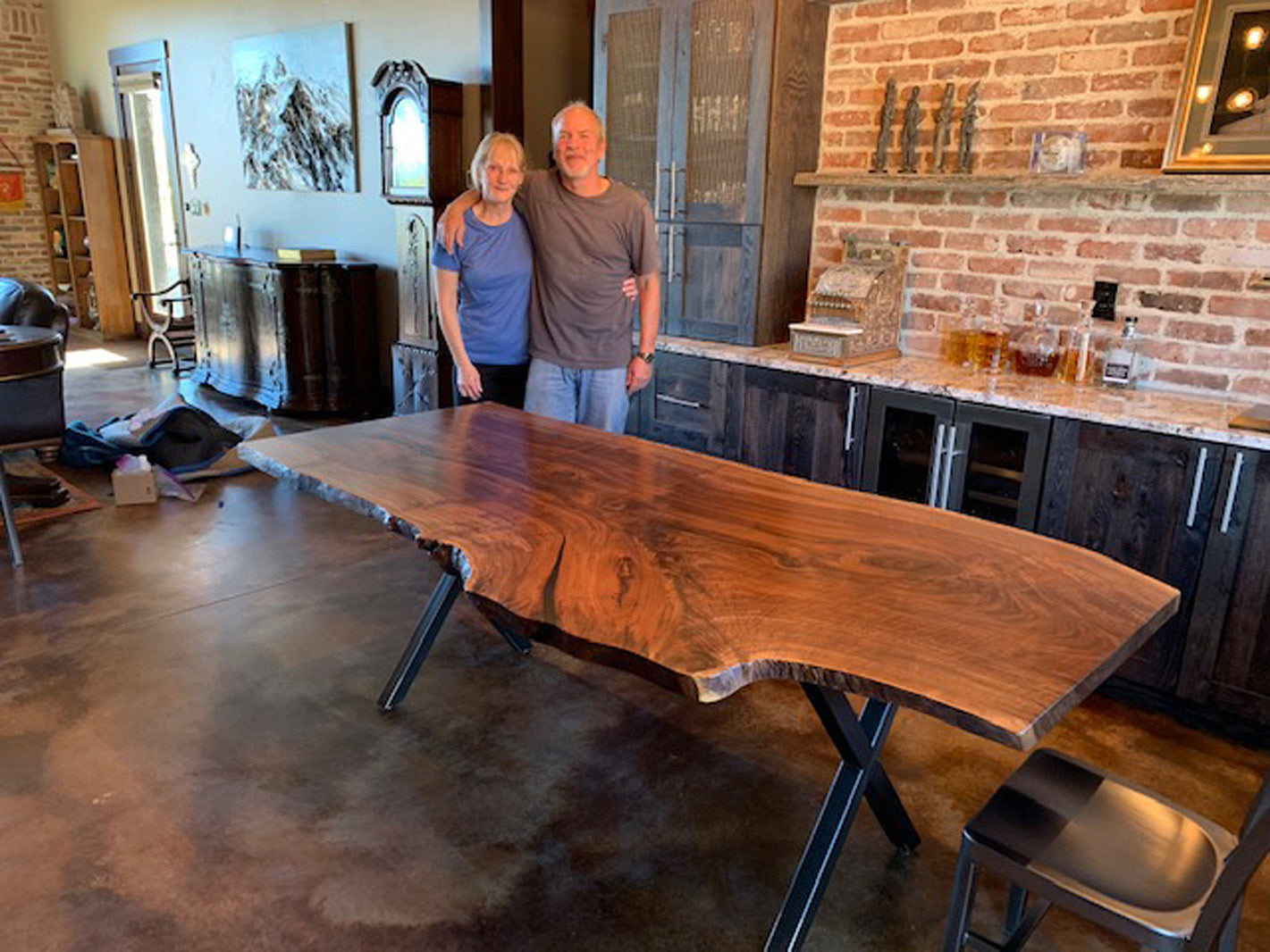 Handcrafted walnut slab dining table and the happy customers who bought it from CS Woods.