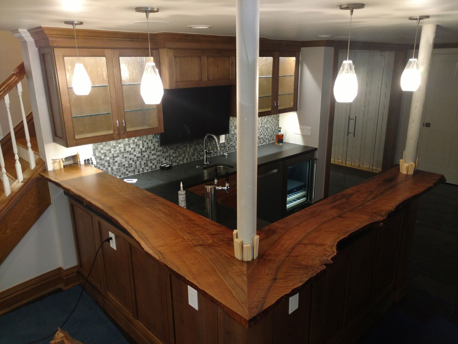 Claro walnut custom fabricated live edge bar top for private residence.