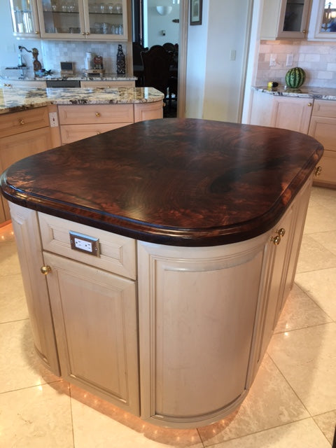Elegant walnut custom solid wood slab kitchen island with OG edge detail.
