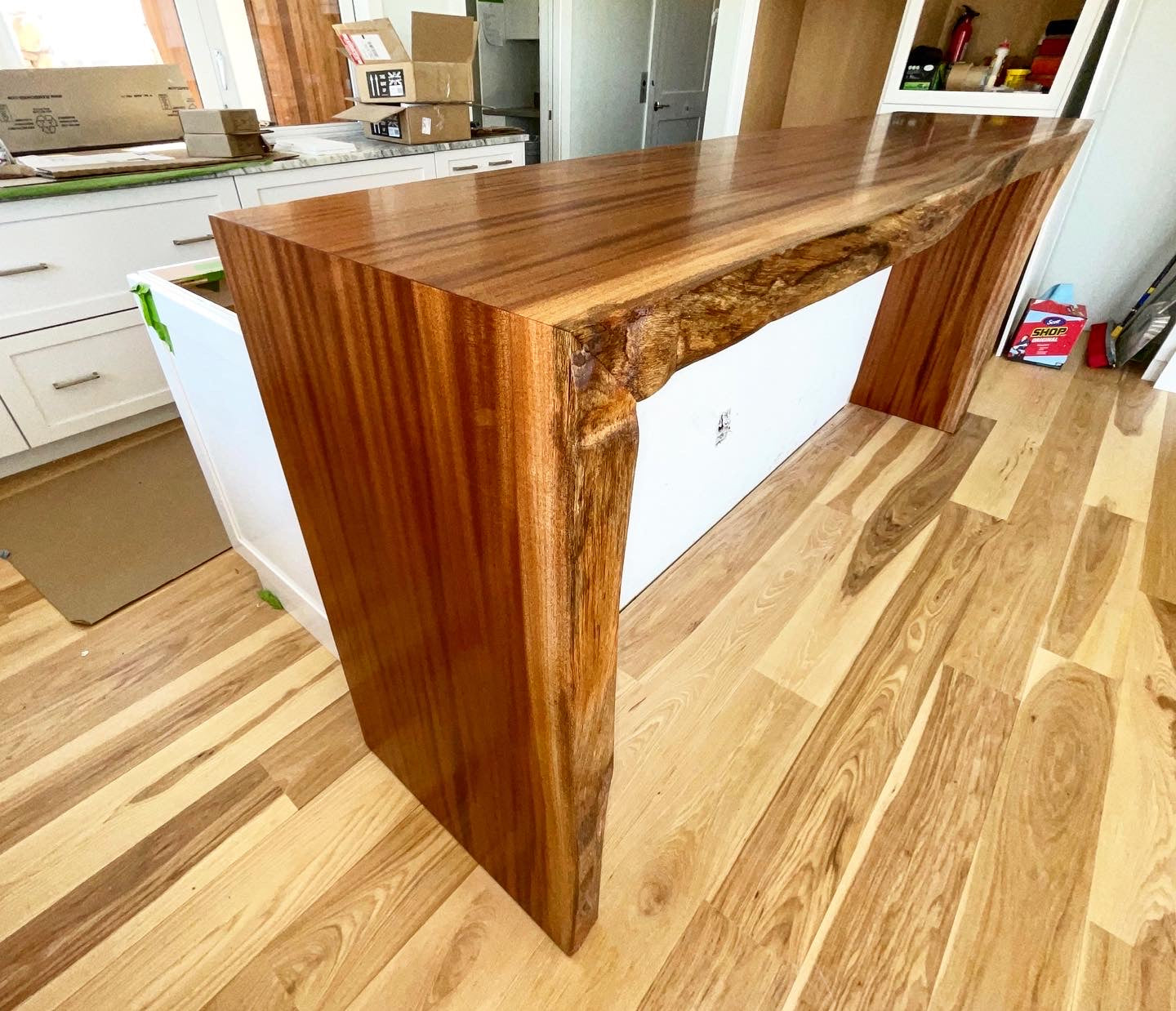 Sapele waterfall one live edge bar top and kitchen island extension at bar stool height.