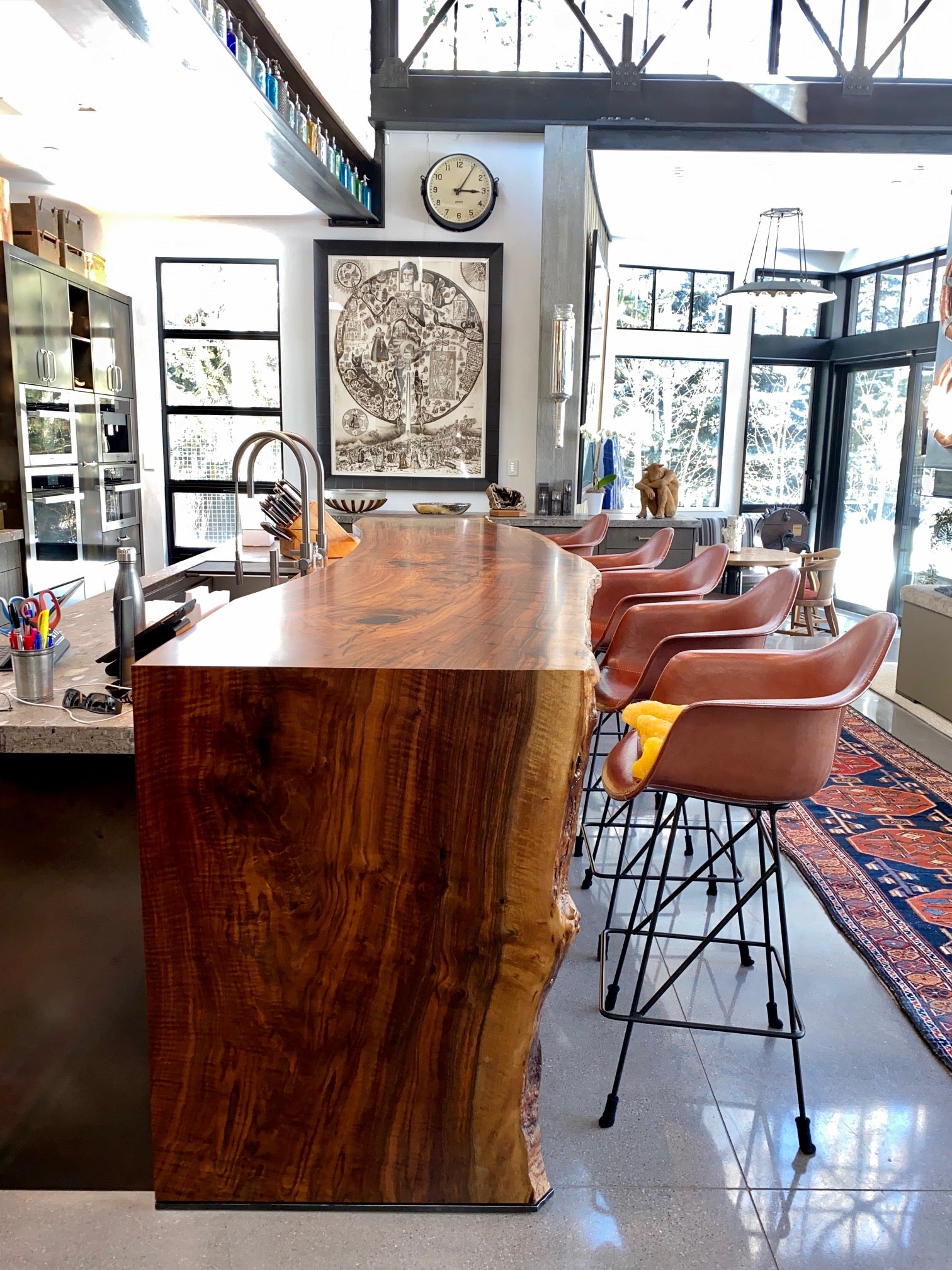Designer kitchen including a live edge kitchen island extension with waterfall legs using a single solid wood Claro walnut slab.