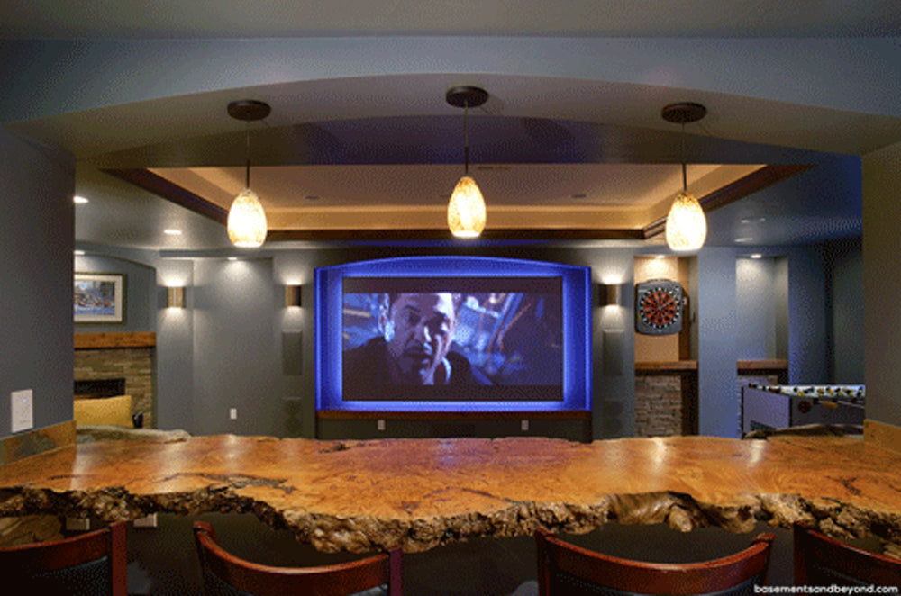 Luxury high end custom home bar area with wood live edge maple burl bar top and private theater.