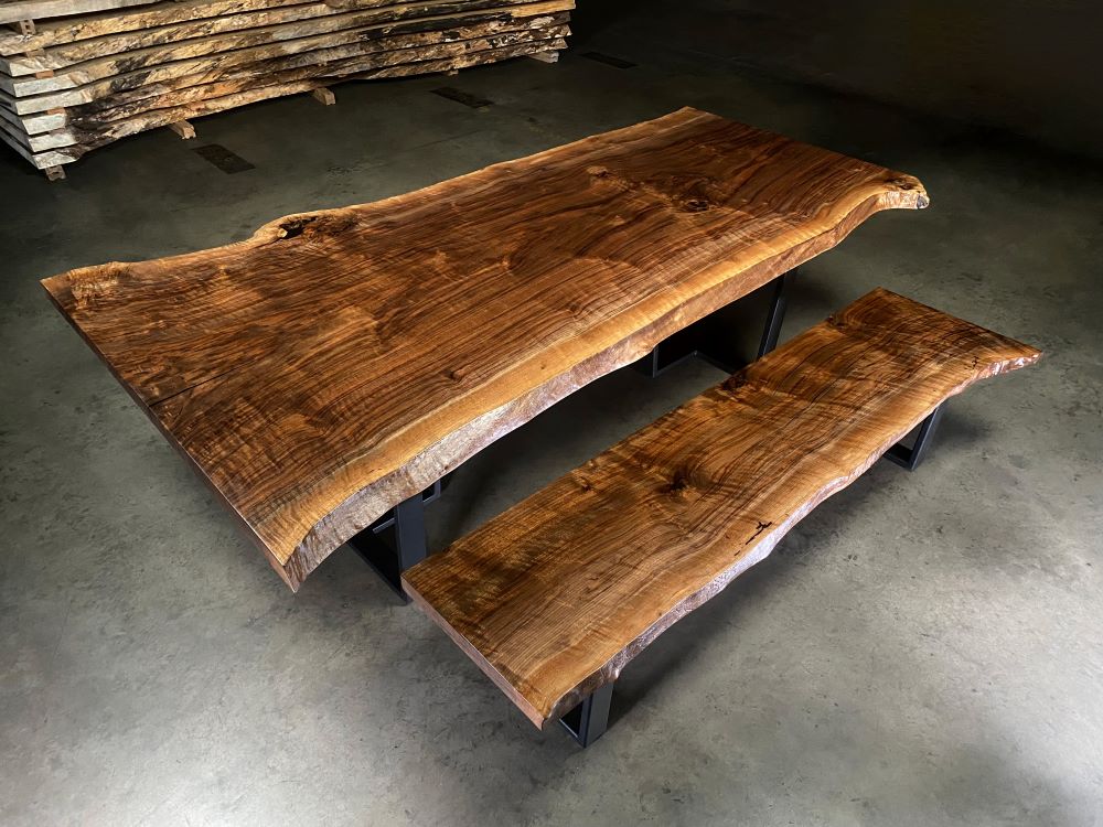 Walnut live edge single slab dining table with match set of walnut benches made from log mates from the same tree. 