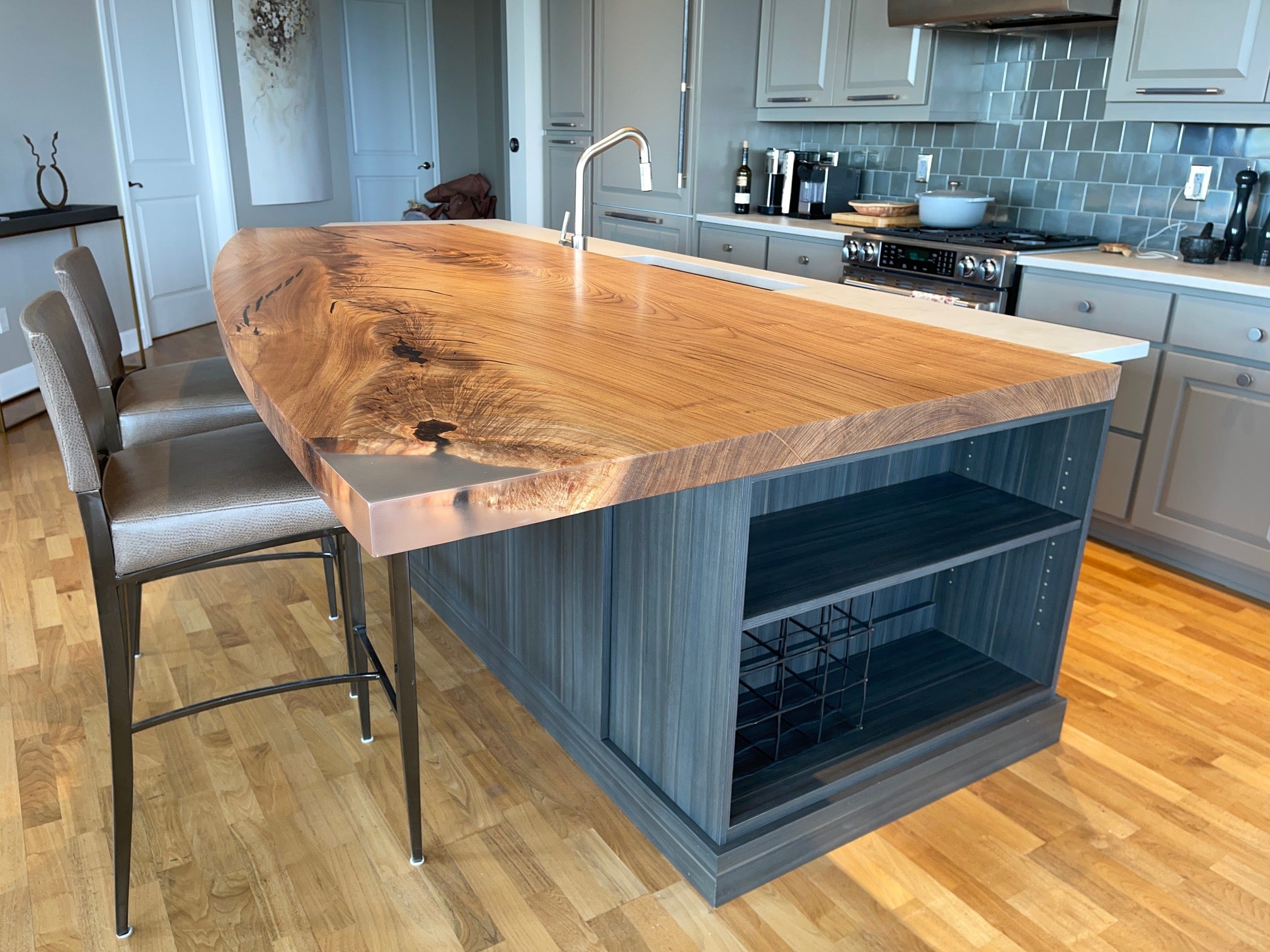 Modern designer kitchen island extension made from an solid wood elm slab with feather figure and epoxy detail. 