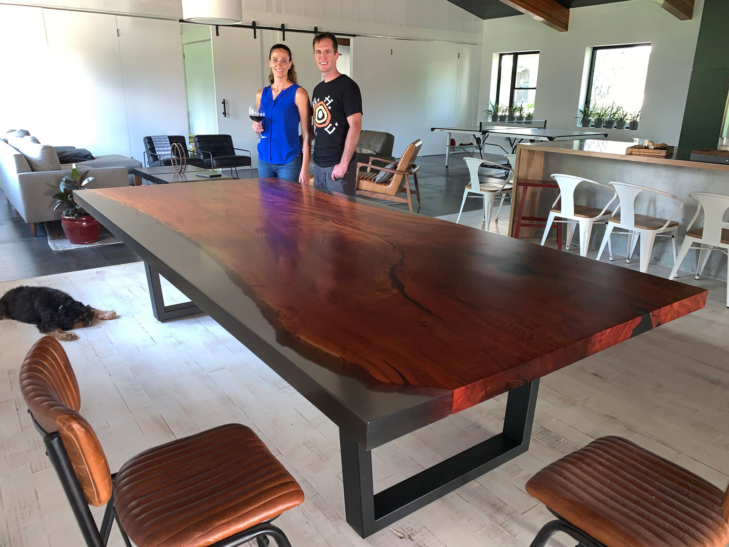 Eucalyptus and clear epoxy resin dining table in modern living room kitchen area. 