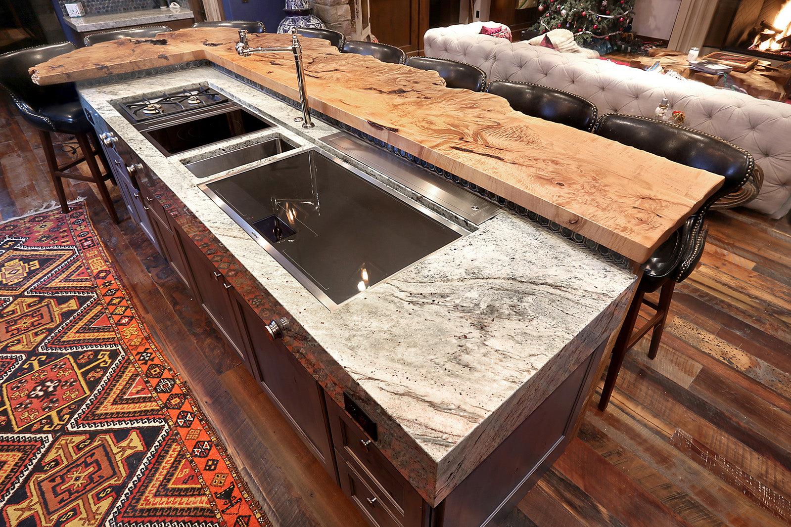 Luxury kitchen design featuring a maple burl kitchen island extension with granite and sink area. 