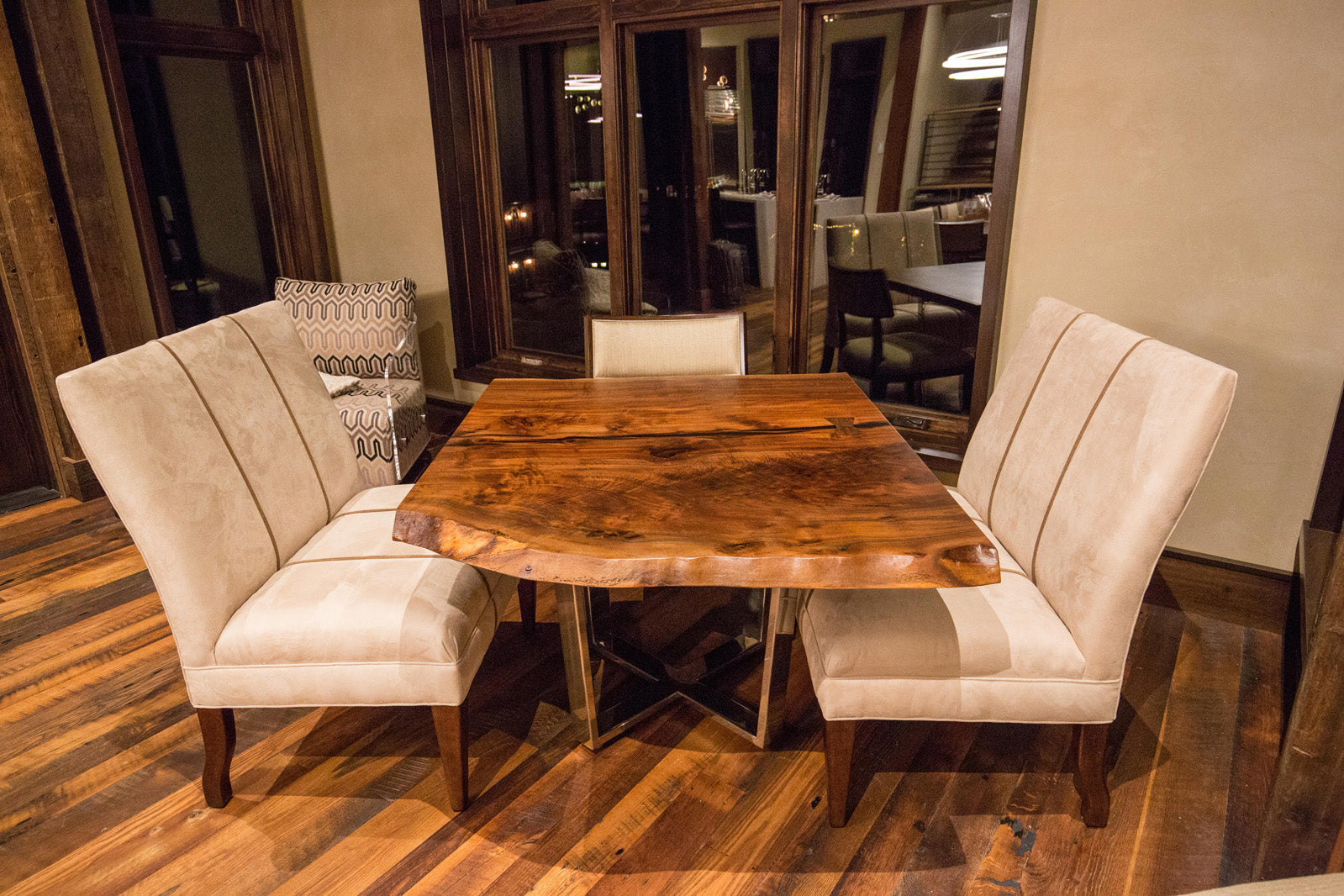 Claro Walnut live edge slab breakfast nook table made by CS Woods with upholstered bench seating. 